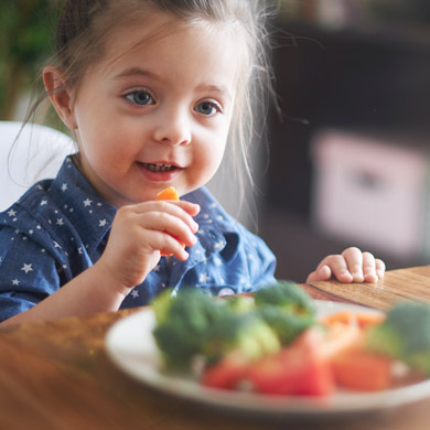 toddler eating healthy veggies